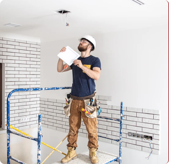 Matrix Renovations contractor inspecting ceiling work at a job site